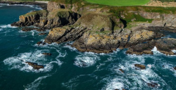 Coastline view waves crashing against cliffs